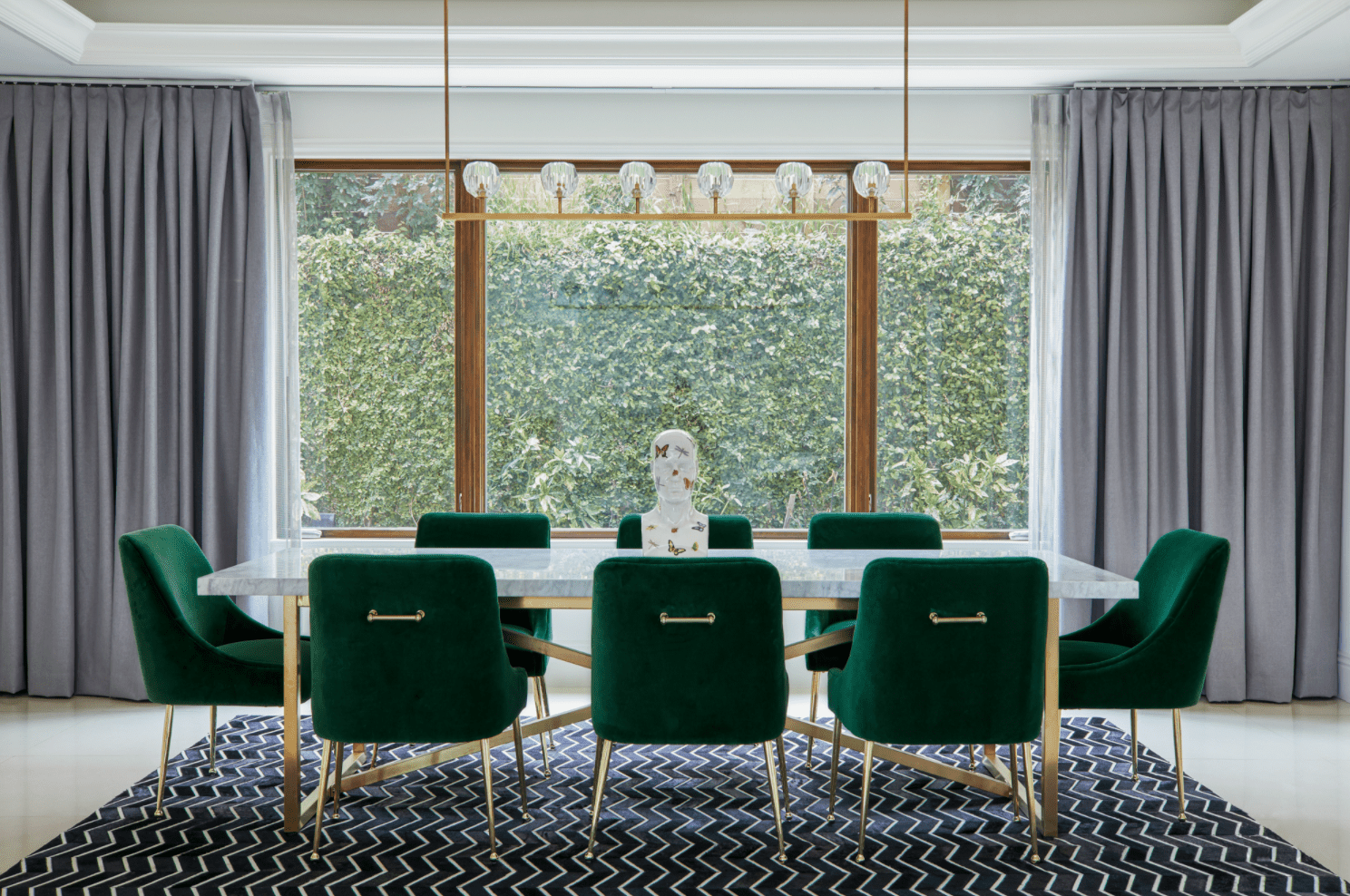 一个带有大窗户的用餐室，厚厚的灰色窗帘，从窗户到墙壁