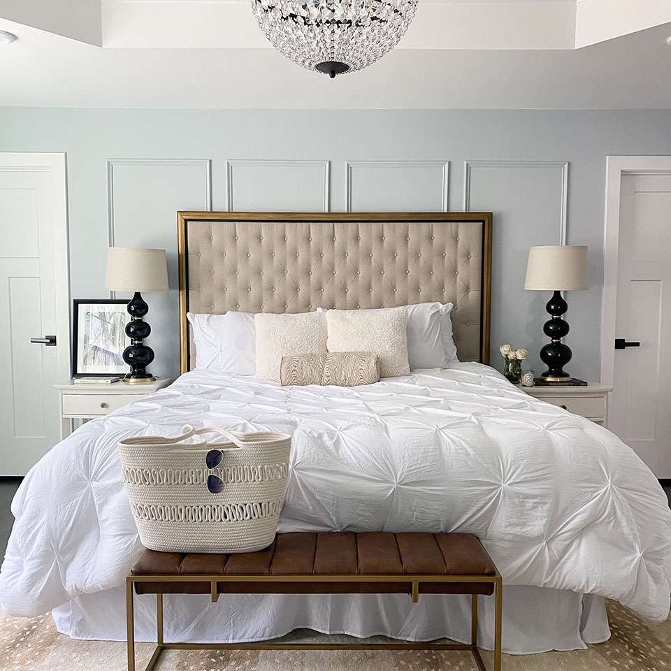 Parisian-inspired bedroom with powder blue accent wall.
