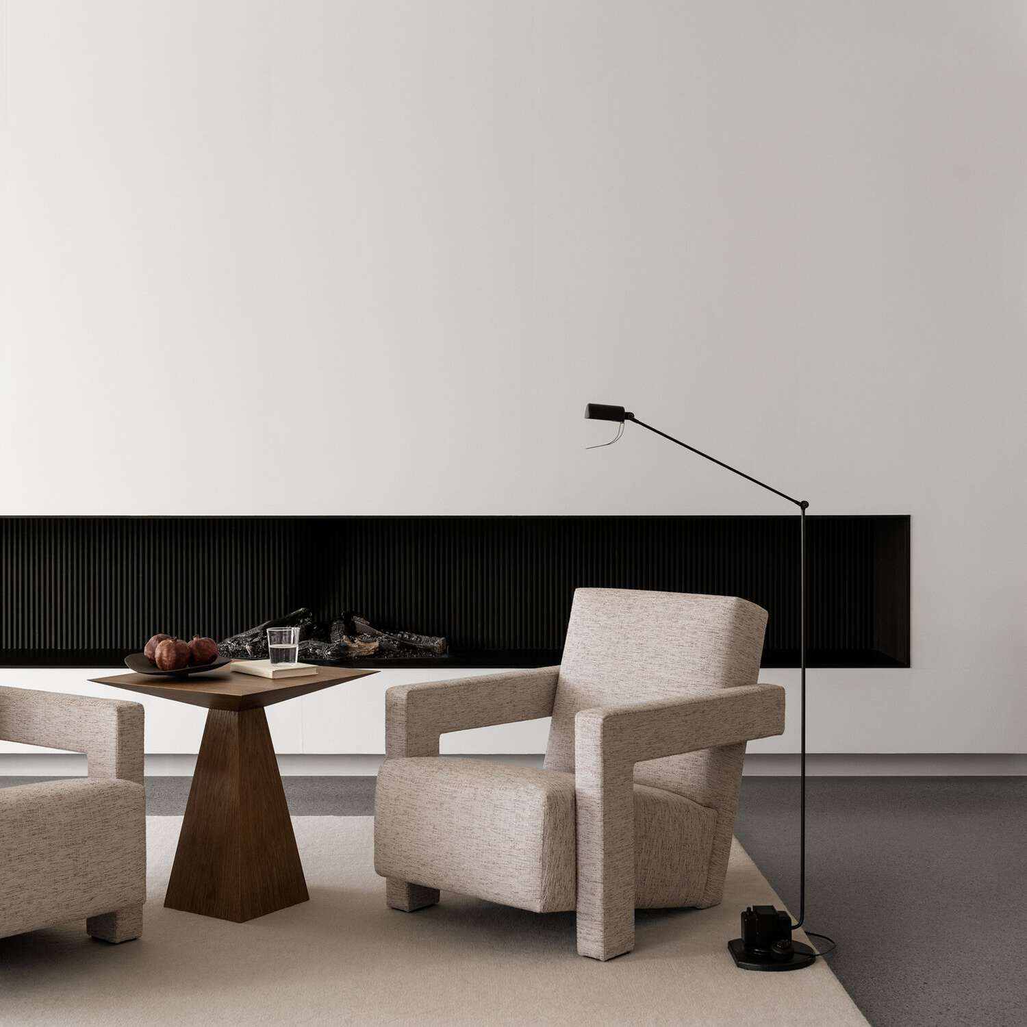 客厅里摆放着时髦的家具，水泥地板上还铺着地毯