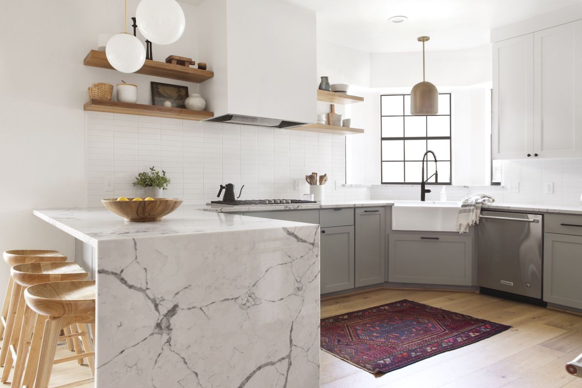 厨房用灰色橱柜，天然木材搁板和白色大理石台面
