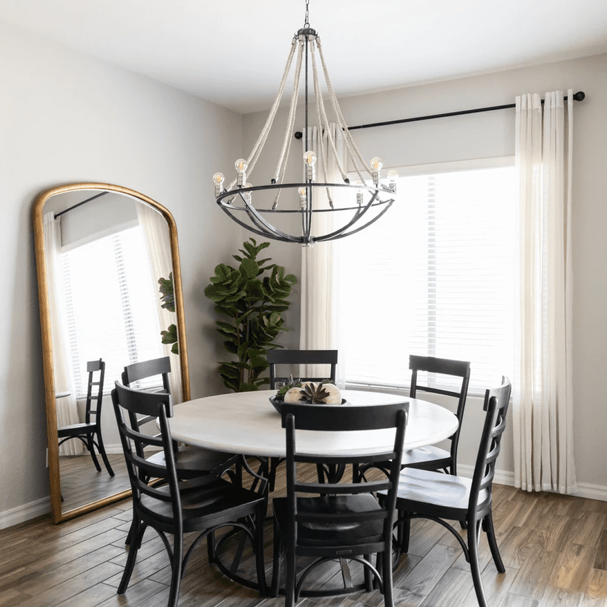 一间装饰着白色的餐厅，突出褶皱窗帘