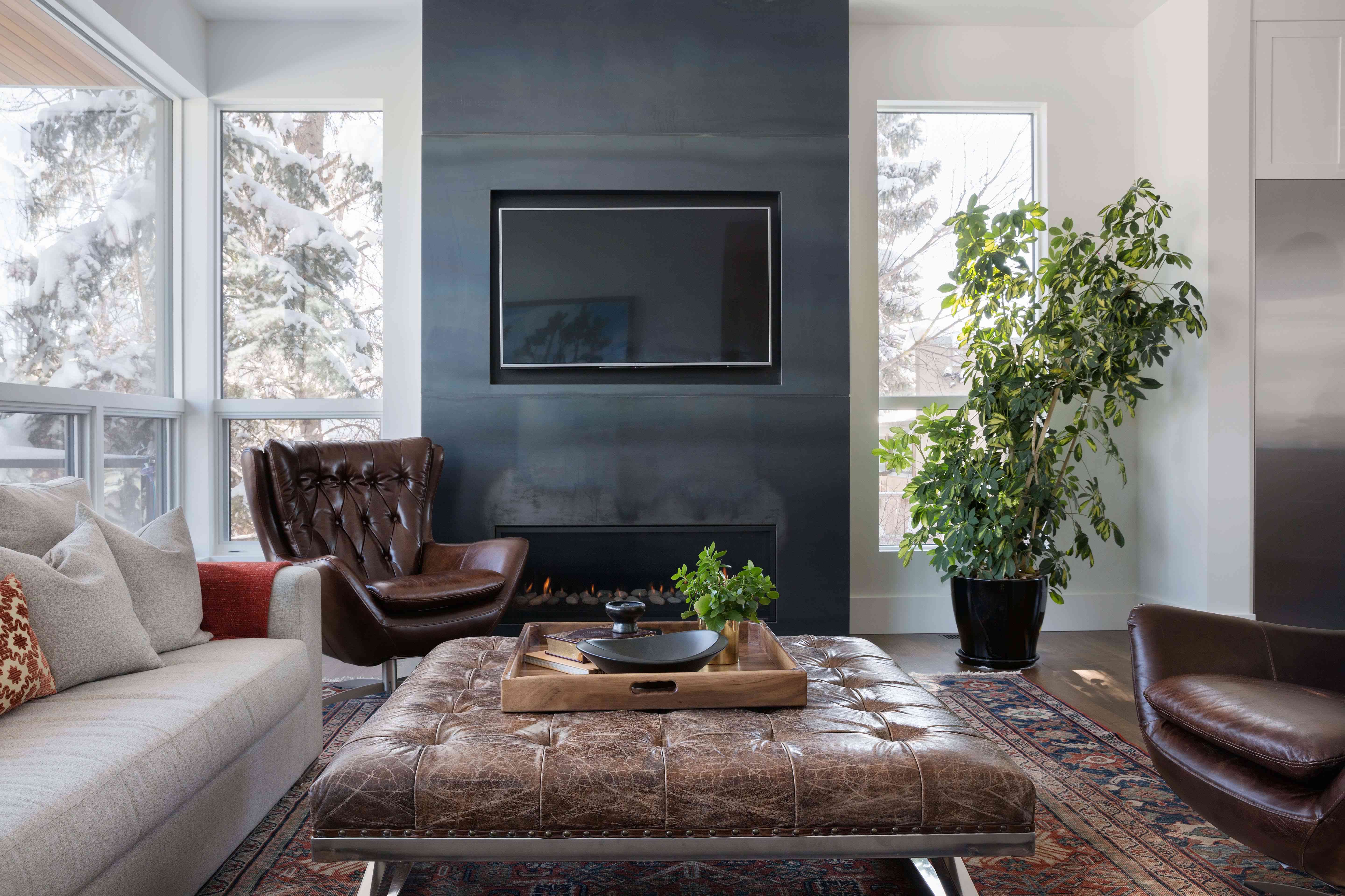 客厅里有现代的皮扶手椅和更传统的皮凳