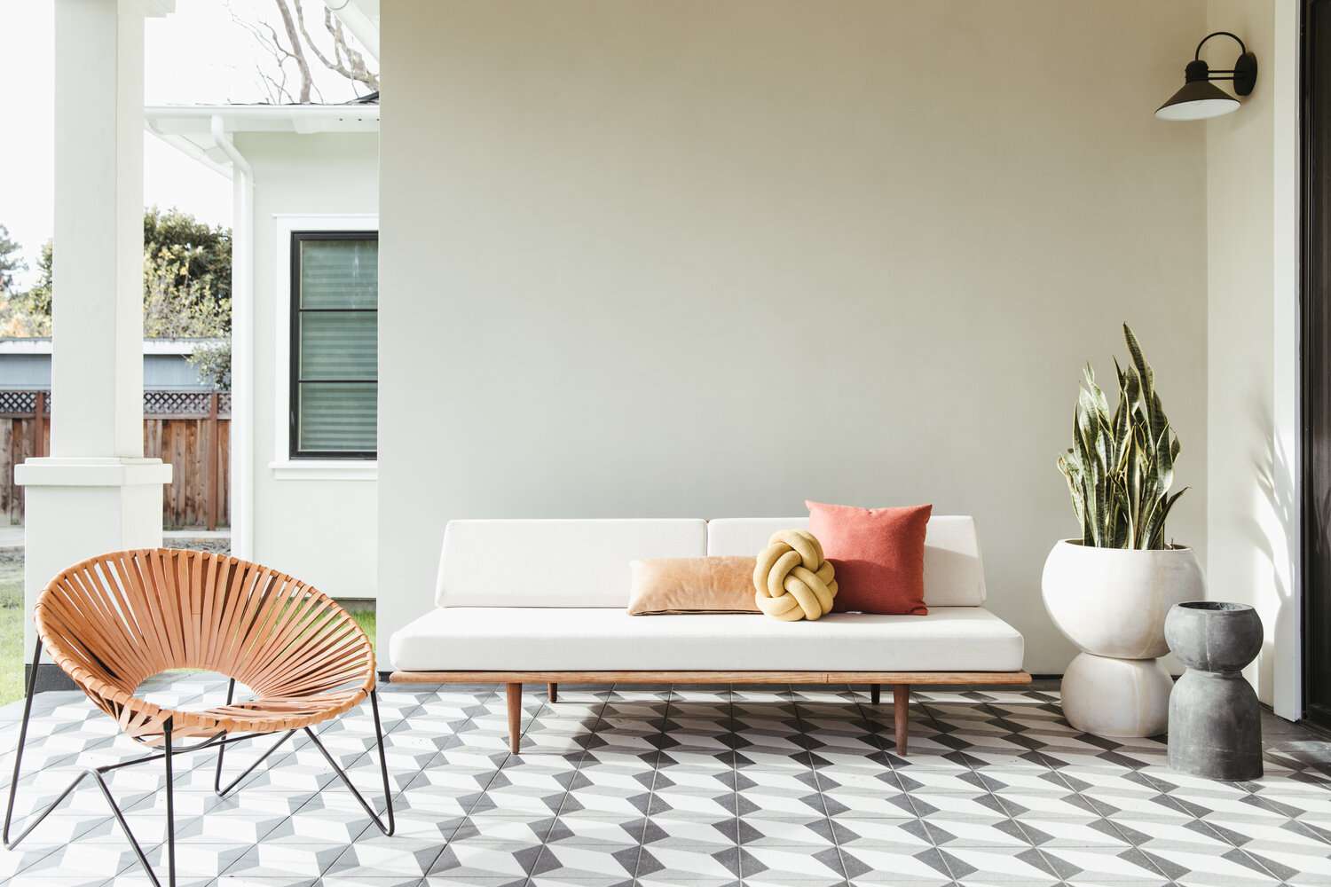 Exterior green wall with outdoor furniture.