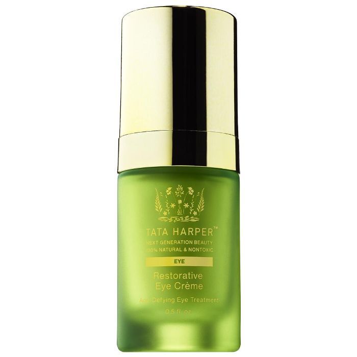 一个金色的绿色玻璃泵眼霜的瓶子。