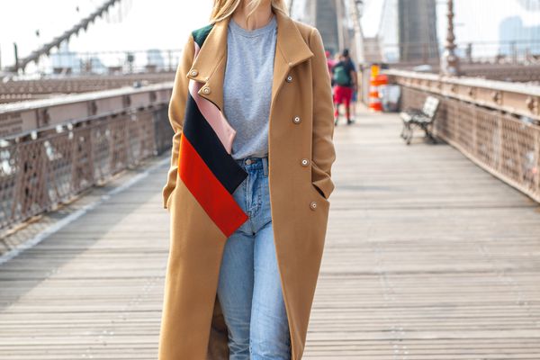 时尚女性在布鲁克林大桥“class=