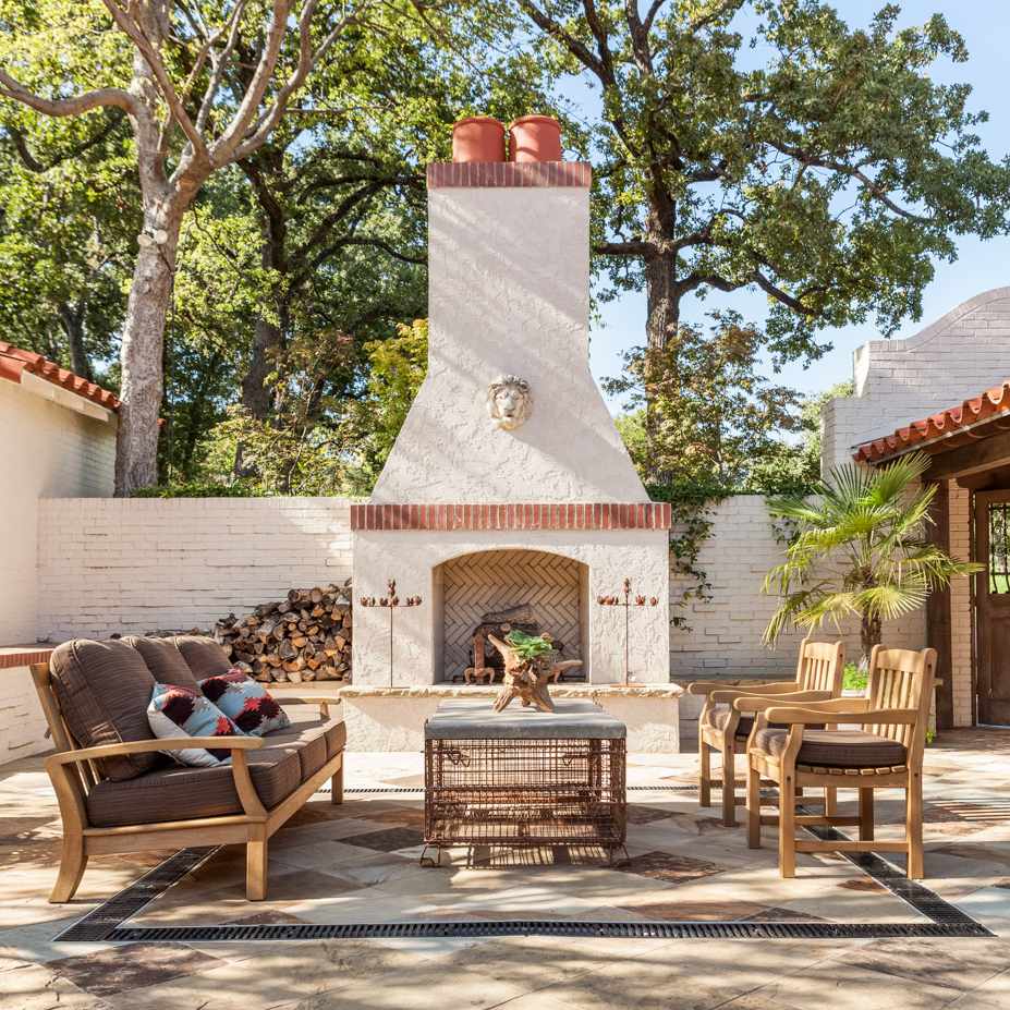 由白色灰泥和红砖制成的户外壁炉，附属于由白色砖和红色灰泥制成的房屋