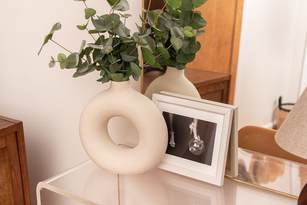 Donut vase filled with greenery.