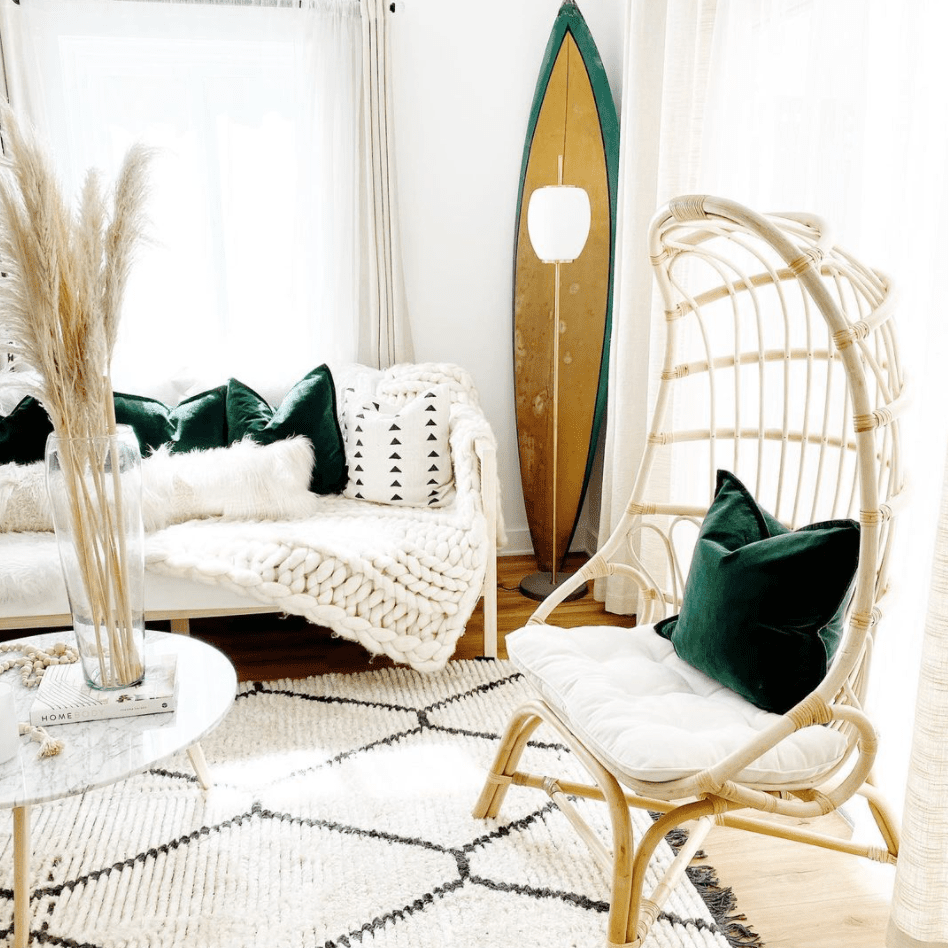 有冲浪板和藤条蛋椅的海滩沿海客厅。