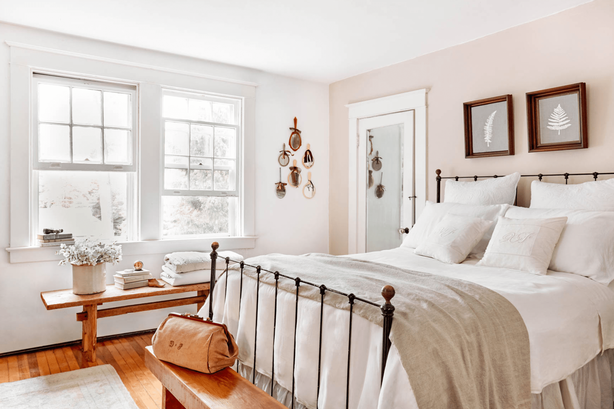Bright bedroom with blush pink accent wall.