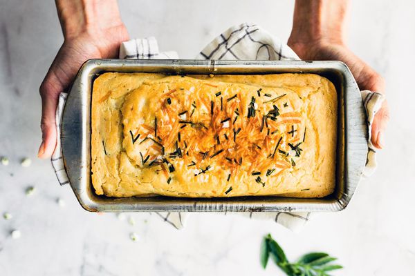 拿着一根罐头烘烤的面包的两只手