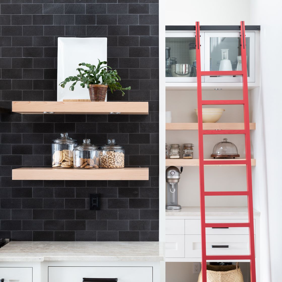 黑白相间的厨房，配上醒目的红色阶梯