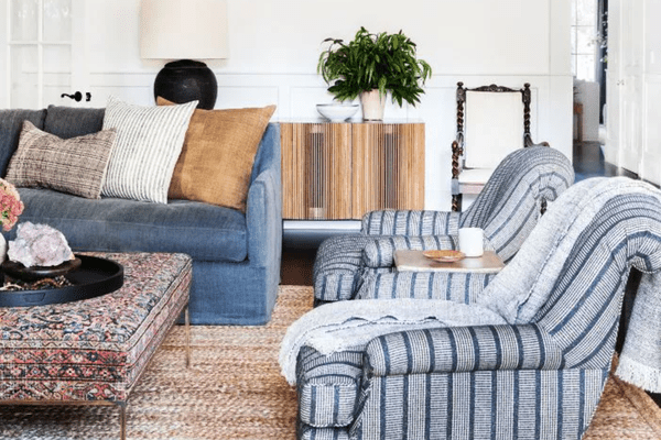 客厅与天然编织地毯和蓝色手臂椅子