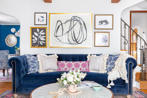 兼收并蓄的客厅，墙上挂着艺术品，天鹅绒沙发。