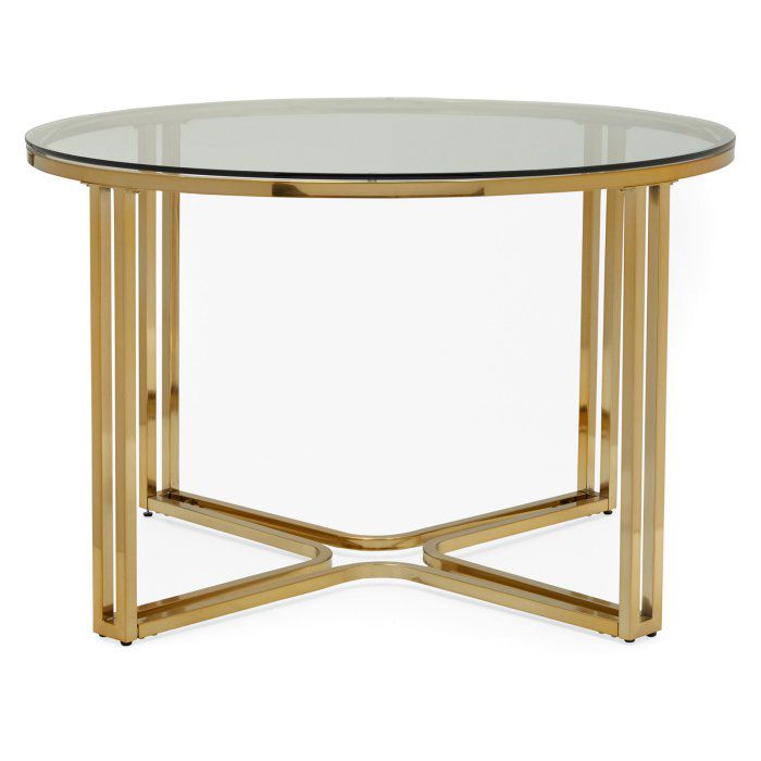 一个圆形的玻璃桌面的餐桌，桌腿是金色的，放在地板上。