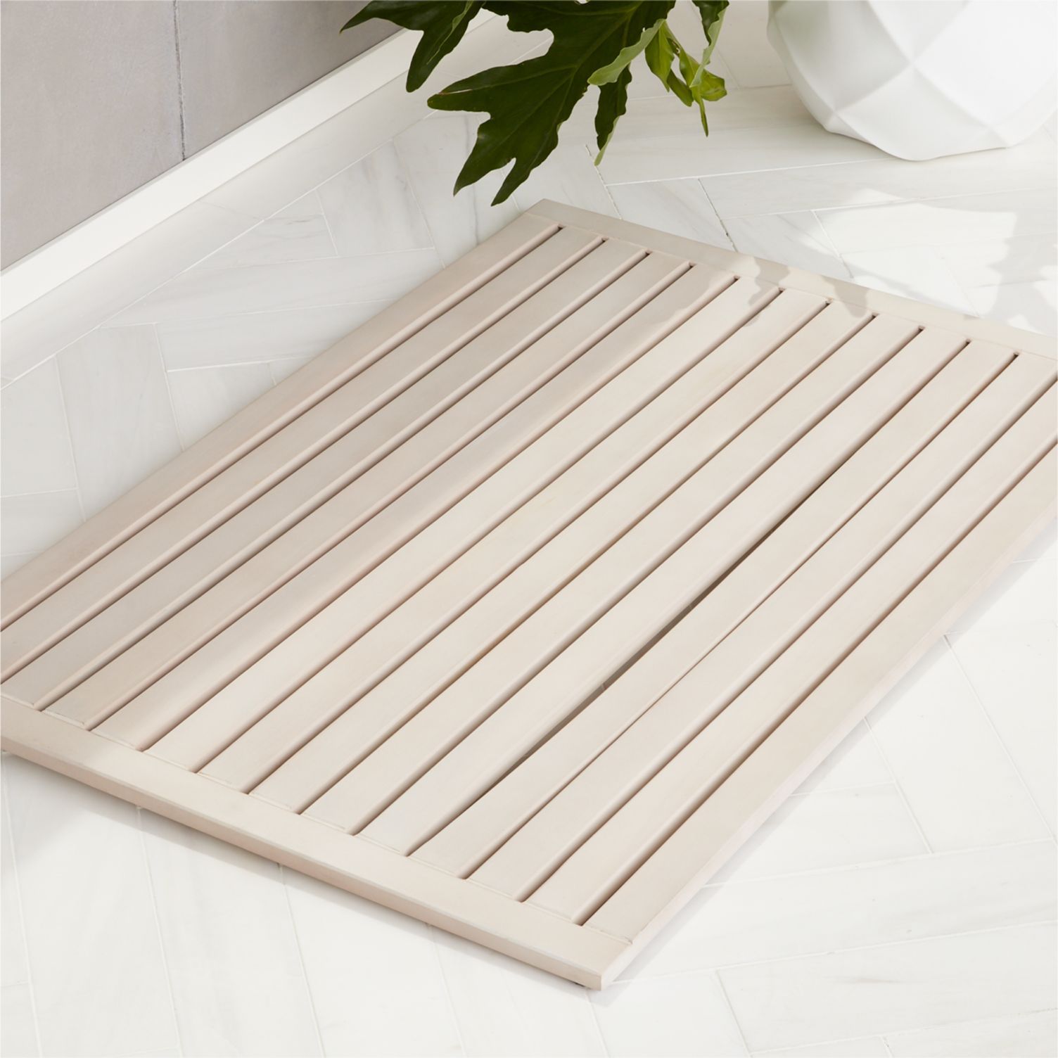 白色的粉刷板条柚木由CB2 bathmat。